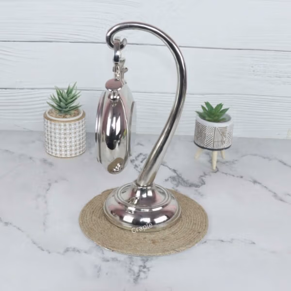 Angled side view of the nickel finish tabletop clock, highlighting the reflective surface of the stand and casing.