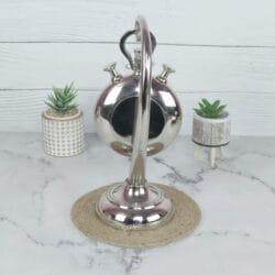 Rear view of the aluminum stopwatch desk clock, showing the back of the casing and the stand's construction.