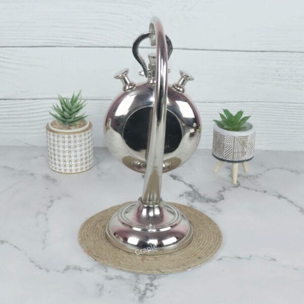 Rear view of the aluminum stopwatch desk clock, showing the back of the casing and the stand's construction.