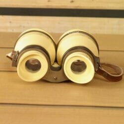 Front view of decorative light yellow aluminum binoculars with angled eyecups and adjustable focus – retro home decor binoculars.