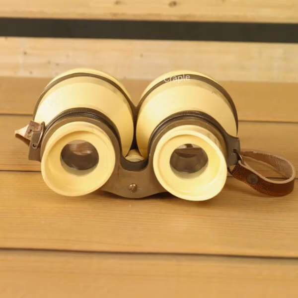 Front view of decorative light yellow aluminum binoculars with angled eyecups and adjustable focus – retro home decor binoculars.
