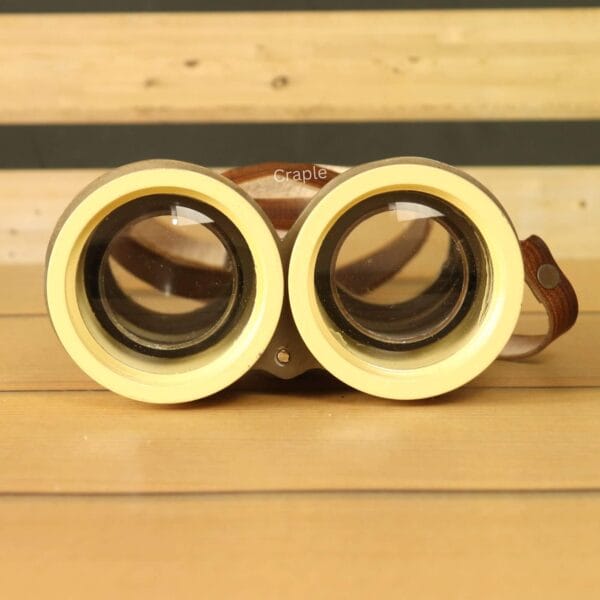 Close-up of the durable leather strap on our retro light yellow binoculars – perfect for vintage decor lovers.