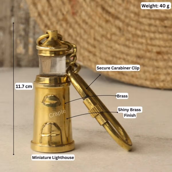 Brass lighthouse keychain with labeled dimensions: 11.7 cm length and 40g weight.