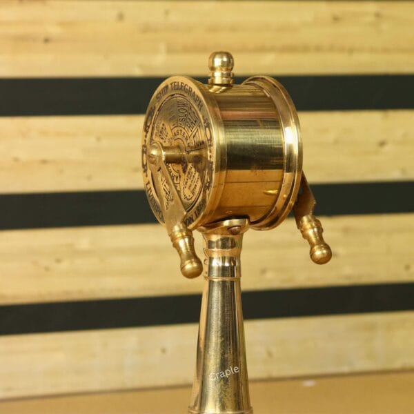 The back and side view of the polished brass engine order telegraph, highlighting its solid construction.