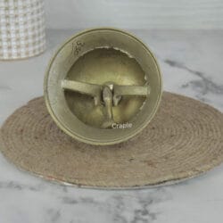 Underside view of the engraved brass bell dome, revealing the internal striker and solid build quality.