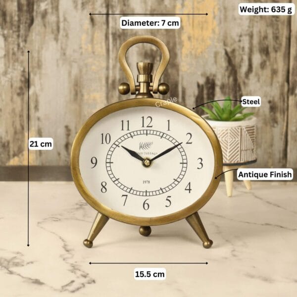 Image of the antique oval clock with labeled dimensions: 21 cm height, 15.5 cm width, and 635g weight.