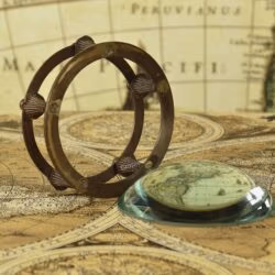 The two-piece desk set showing the glass dome magnifier placed next to its antique-finish brass gimbal holder.