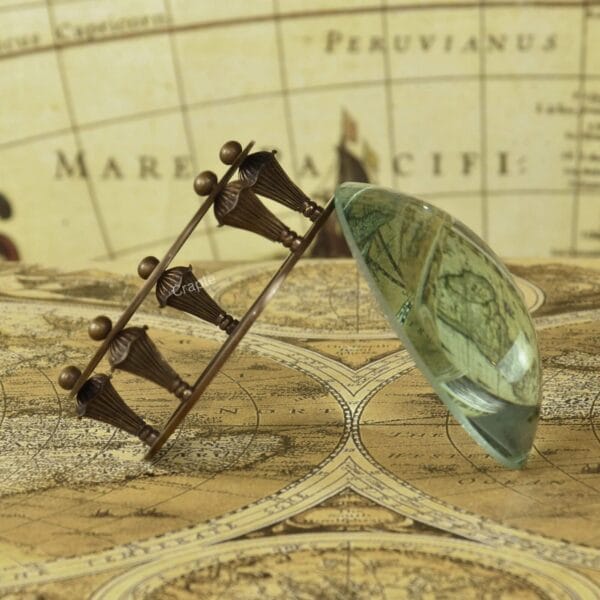 The adjustable brass gimbal stand for the paperweight magnifier, tilted to the side to show its range of motion.