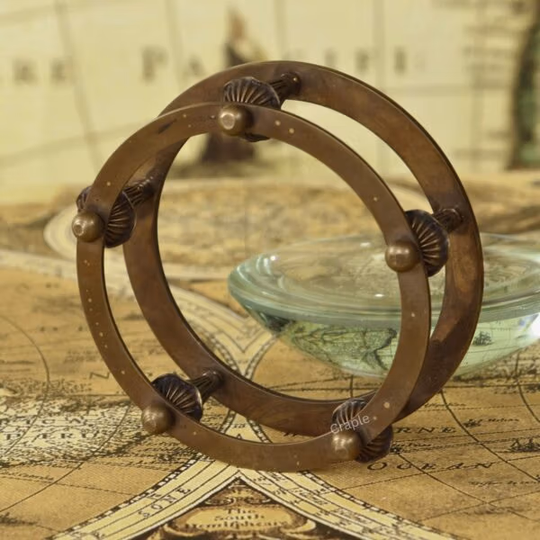 Paperweight Brass Desk Magnifier-5 Detailed close-up of the intricate design and antique finish on the brass armillary-style stand.