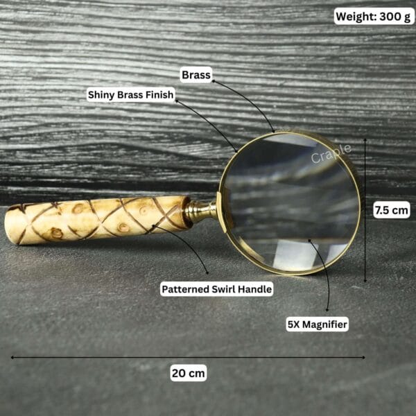 Brass magnifier with labeled specifications: 20 cm length, 7.5 cm lens, 300g weight, and 5X magnification.