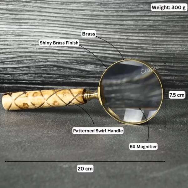 Brass magnifier with labeled specifications: 20 cm length, 7.5 cm lens, 300g weight, and 5X magnification.