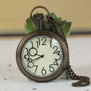 Antique brass pocket watch with a unique quirky artistic numeral dial and a matching chain.