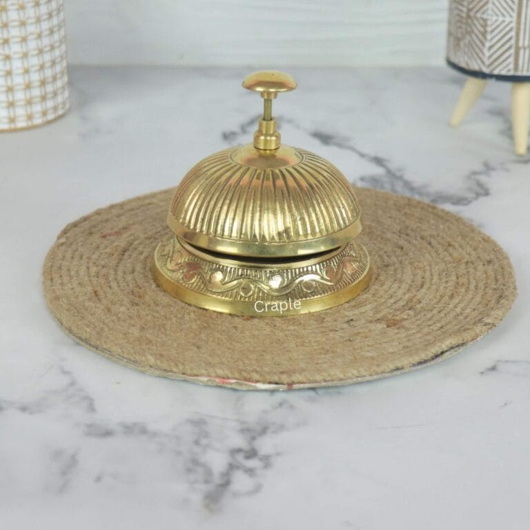 Vintage-style brass service desk bell with a fluted top and ornate engraved base, for a hotel or reception