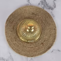 Top-down view of the golden brass service bell, showing the detailed fluted pattern on the dome and the push-button.