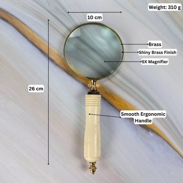 Infographic showing the brass magnifier's dimensions: 26 cm length, 10 cm lens, 310g weight, and 5X magnification.