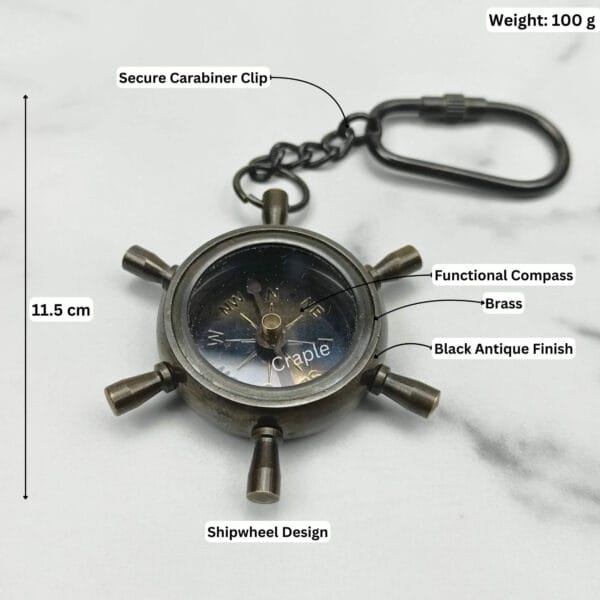 Features a secure carabiner clip and a functional compass. Total length is 11.5 cm.