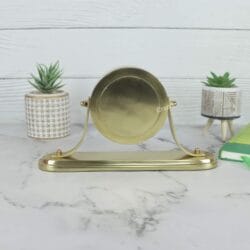 Direct back view of the swiveling desk clock, showcasing the polished golden finish of the aluminum casing.