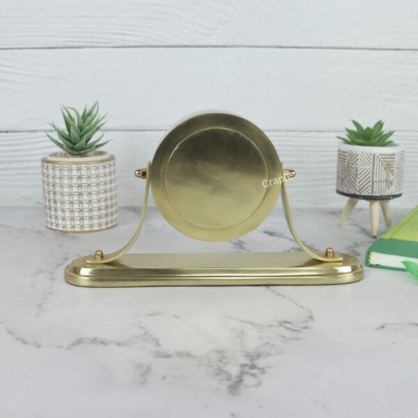 Direct back view of the swiveling desk clock, showcasing the polished golden finish of the aluminum casing.