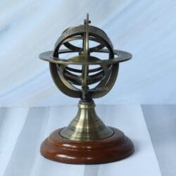 Front view of a small decorative brass armillary sphere with an antique finish, mounted on a polished wooden base.