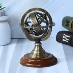Decorative small brass armillary sphere with an antique finish, shown as a sophisticated centerpiece on its polished wood base.