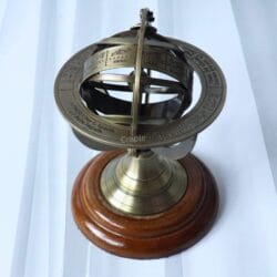High-angle view of the tabletop armillary sphere, showing the engraved celestial rings and brass construction.
