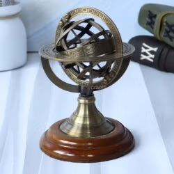 Angled side view of the antique brass armillary globe, highlighting its interlocking ring design.