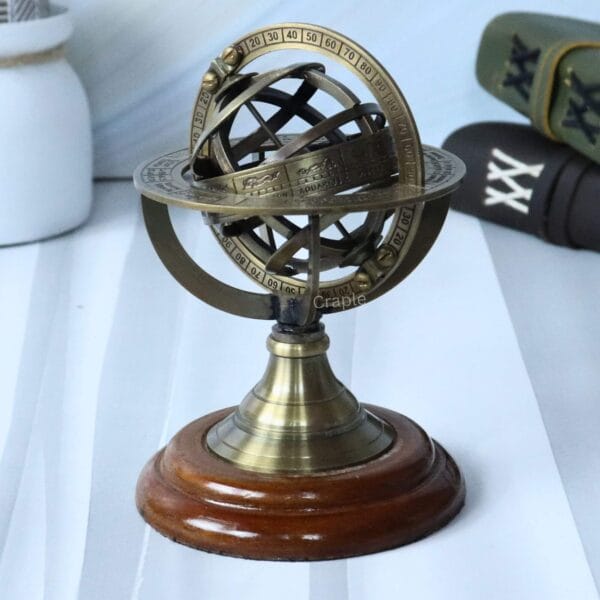 Angled side view of the antique brass armillary globe, highlighting its interlocking ring design.
