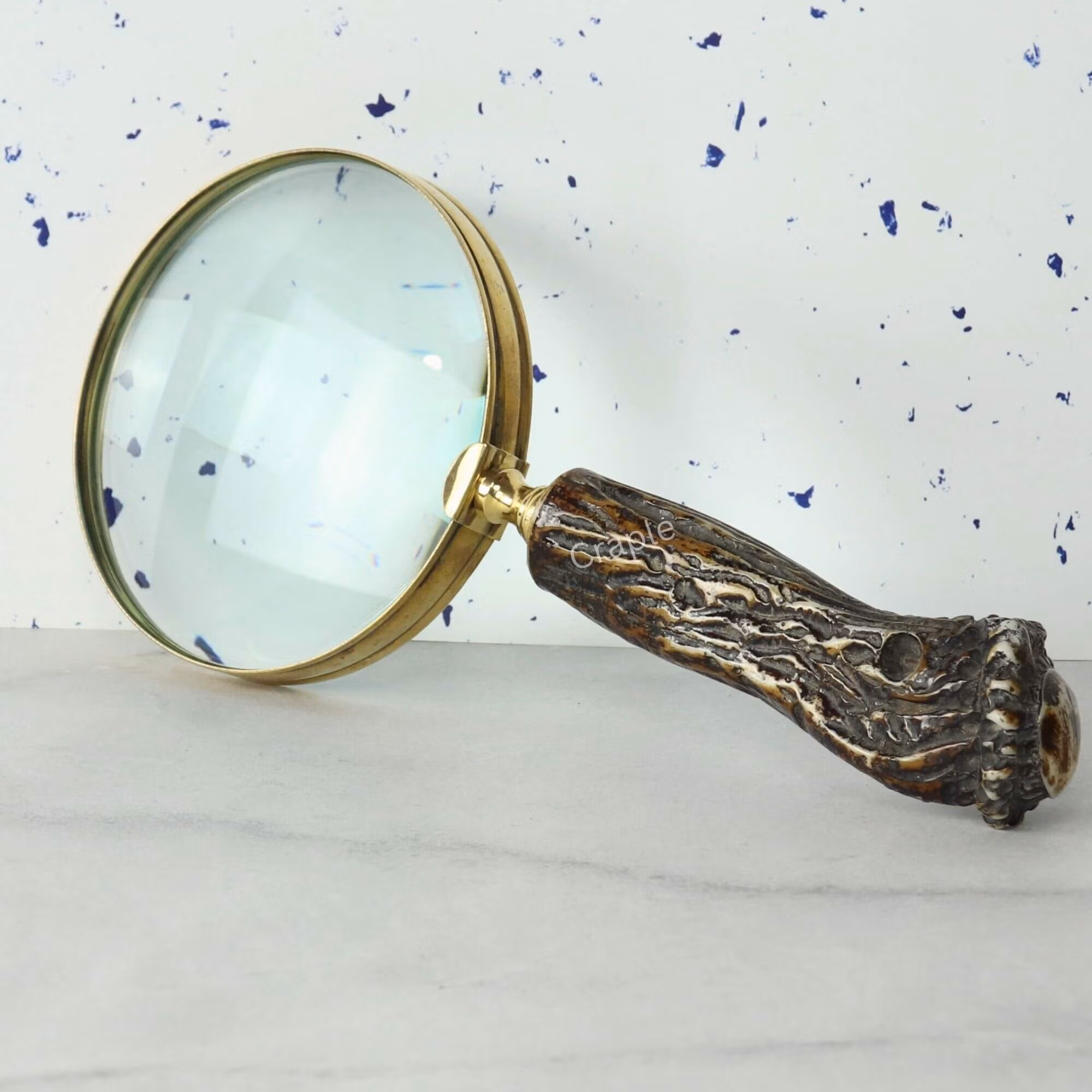 Tree Trunk Style Handle Magnifier-2 Close-up of a decorative magnifying glass with a 5X lens, shiny brass rim, and a highly detailed, textured tree trunk style handle.