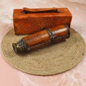 Vintage leather-wrapped brass telescope and its embossed case, styled on a coiled jute rope for a nautical theme.