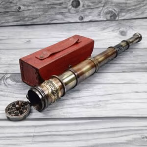 Antique brass Royal Navy telescope fully extended, with its eyepiece lens cap removed, displayed next to a handcrafted red leather box.