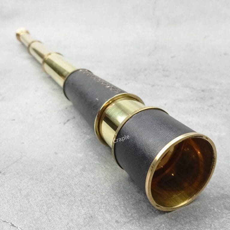 Vintage nautical telescope with a leather-wrapped body and a shiny brass finish, shown fully extended.