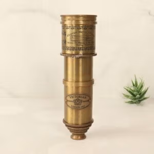 Vintage Victorian marine telescope made from antique brass, shown fully collapsed to highlight its decorative engravings.