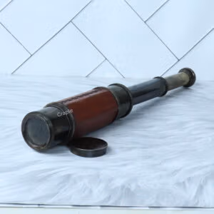 A leather-wrapped W. Ottway 1915 replica spyglass, partially extended to show its brass sections, with the lens cap nearby.