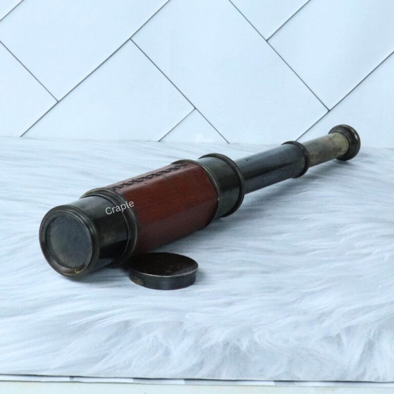 A leather-wrapped W. Ottway 1915 replica spyglass, partially extended to show its brass sections, with the lens cap nearby.