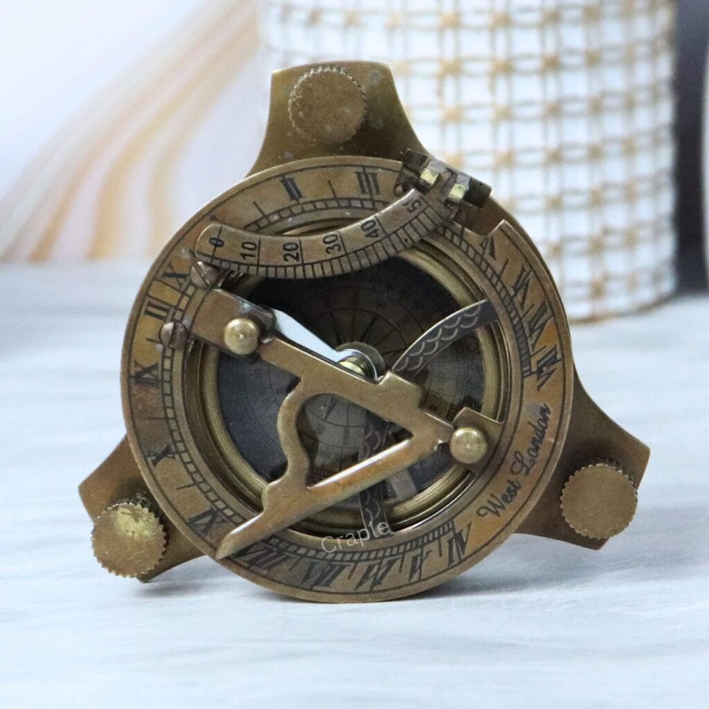 Antique brass sundial compass with a vintage finish, featuring an adjustable sundial gnomon and Roman numerals.