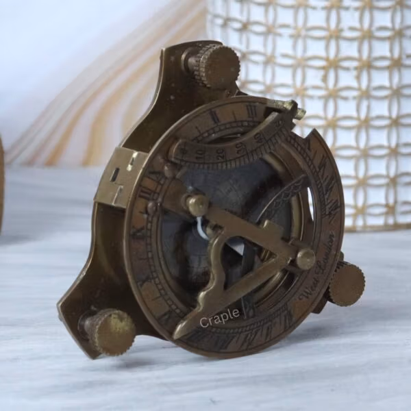 A side view of the antique brass navigational instrument, highlighting its sturdy build and craftsmanship.