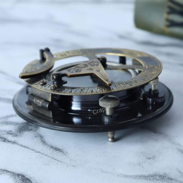Antique Brass-Silver Sundial Compass-2 Side view of the antique brass and silver sundial compass, showing its adjustable tripod legs and intricate construction.
