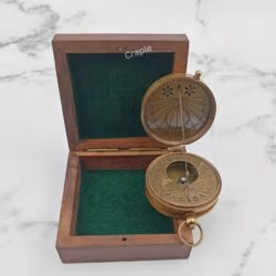 Vintage-style string sundial compass with an antique brass finish, shown open next to its wooden case.