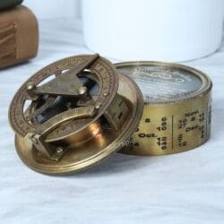 Antique brass Dollond London sundial compass with its engraved lid open, showing the internal sundial and compass.