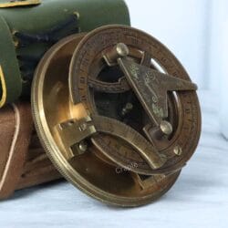 Angled perspective of the open brass sundial compass, highlighting its antique finish and intricate details.