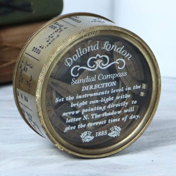 Side profile of the antique brass pocket sundial compass, displaying the detailed calendar and month markings.