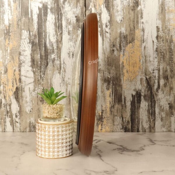 Direct side profile of the vintage wall clock, demonstrating its slim profile and smooth wooden construction.