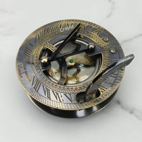 Black Antique Brass Sundial Compass-5 Antique brass sundial compass with a black finish, featuring a detailed sundial face with Roman numerals and an internal compass.