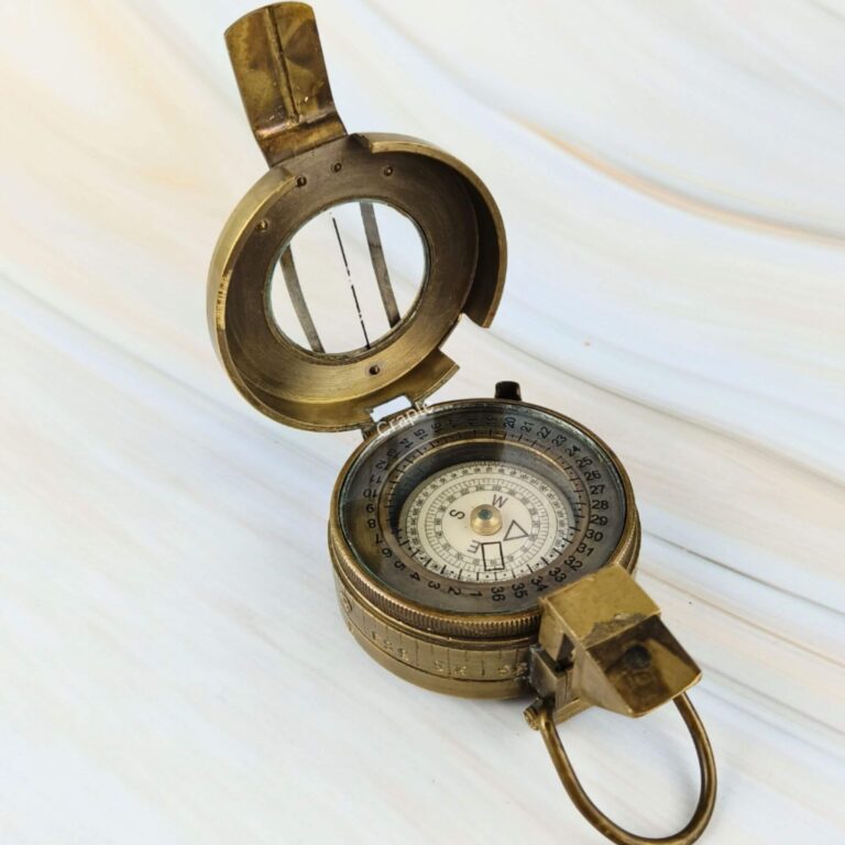 Antique brass British WWII prismatic compass shown open, detailing the internal compass dial and the flip-up prism sight.
