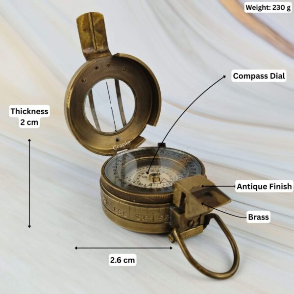 Brass prismatic compass with its dimensions labeled, showing a 2.6 cm width, 2 cm thickness, and 230g weight.