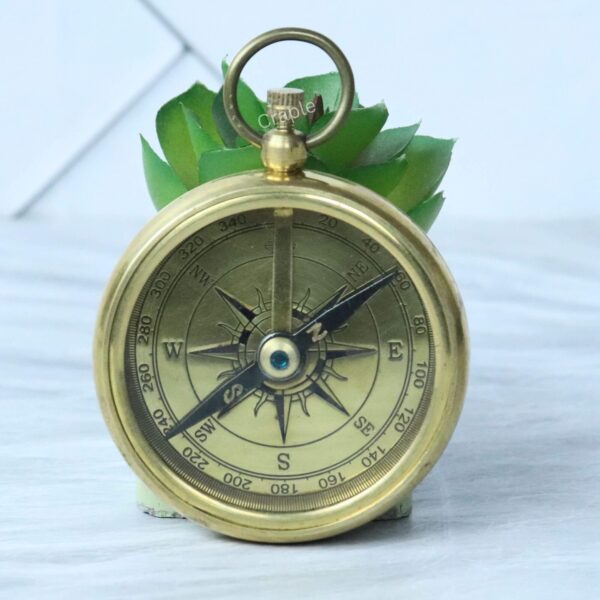 Classic Open Face Pocket Compass-1 A vintage-style open-face pocket compass made of shiny brass, featuring a classic compass rose dial.