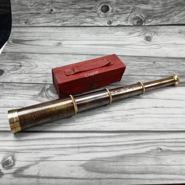 Vintage-style Dollond London brass and leather telescope shown collapsed next to its red leather storage case.
