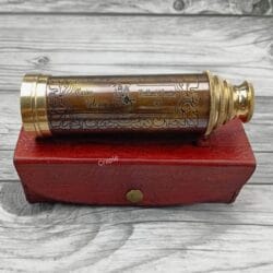 Antique-finish brass telescope with a leather-wrapped, intricately engraved main barrel.