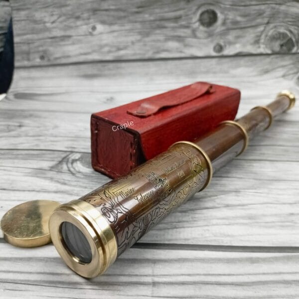 Close-up of the brass objective lens of the vintage nautical telescope with its matching brass lens cap removed.
