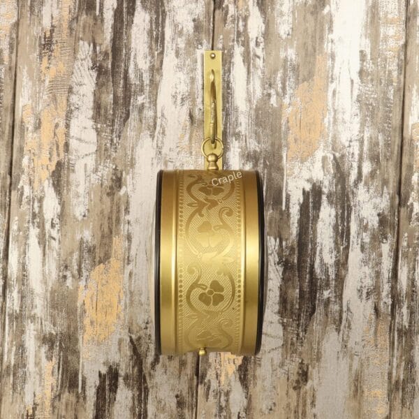 Side view of the vintage-style station clock hanging from its wall bracket, showcasing the decorative embossed casing.